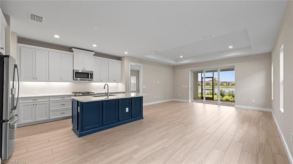 4568 Centaurus Circle Naples, FL 34120 - Photo 7 of 47 a large kitchen with stainless steel appliances granite countertop a stove a sink and a refrigerator