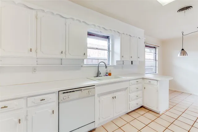 a kitchen with white cabinets and white appliances