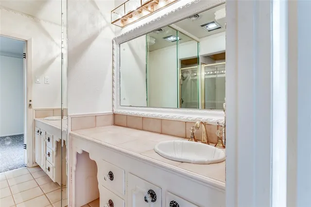 a bathroom with a double vanity sink and mirror