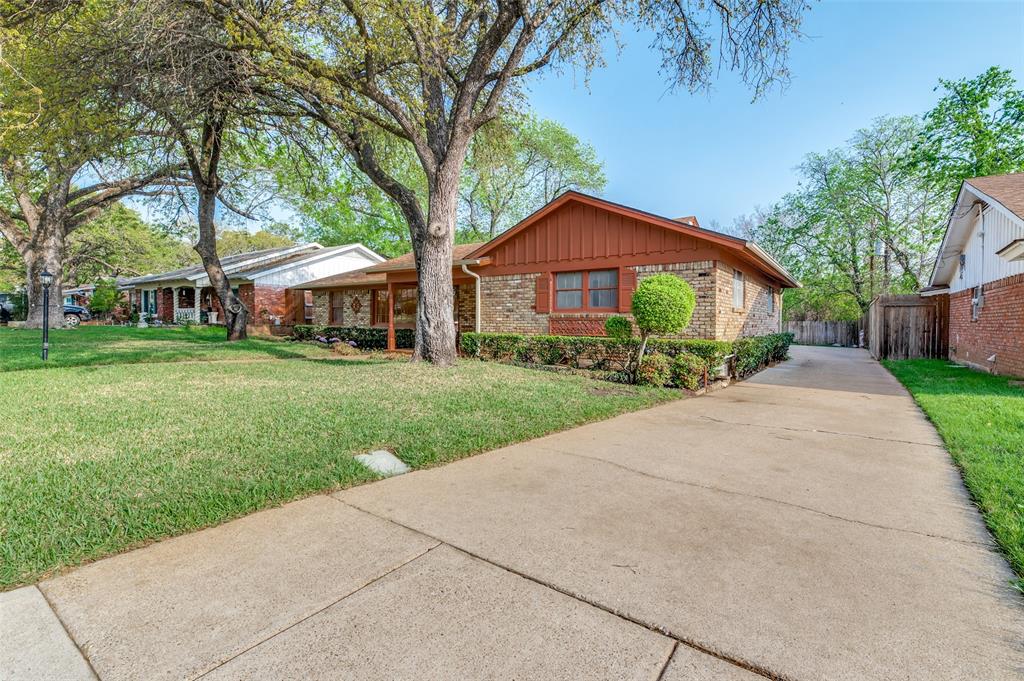 6809 Yolanda Drive Fort Worth, TX 76112 - Photo 3 of 22 a front view of a house with a yard and potted plants