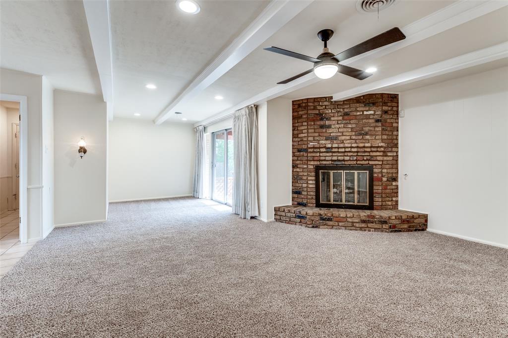 6809 Yolanda Drive Fort Worth, TX 76112 - Photo 8 of 22 a view of an empty room with a fireplace and a large window
