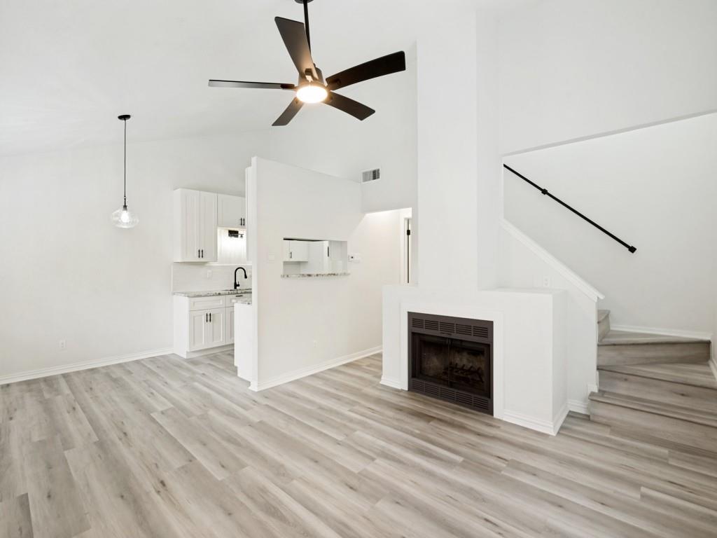2240 Tarpley Road, Unit 92 Carrollton, TX 75006 - Photo 2 of 22 a view of a livingroom with wooden floor and a ceiling fan