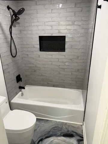 a bathroom with a toilet and a shower