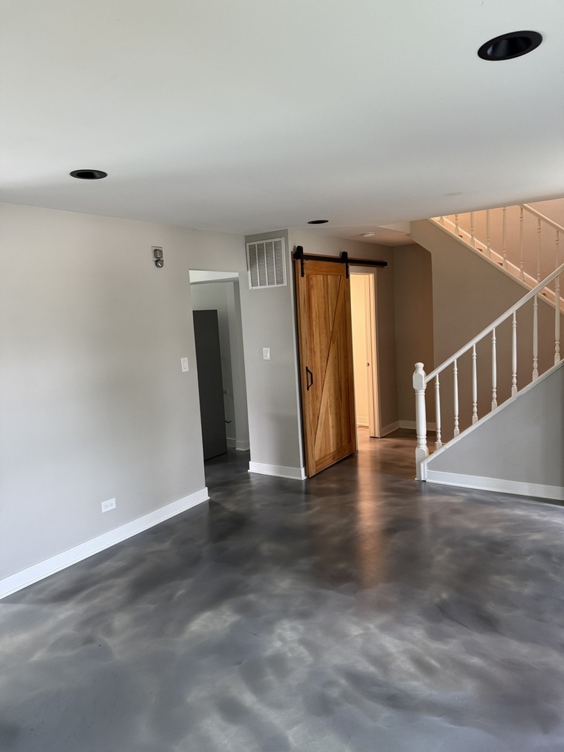 4539 Huntington Boulevard Hoffman Estates, IL 60192 - Photo 3 of 16 a view of an empty room with wooden floor and windows