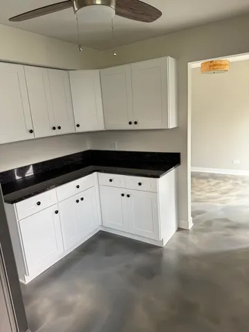 a kitchen with white cabinets and white appliances