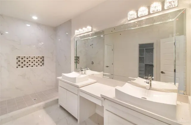 a bathroom with a sink double vanity and a mirror
