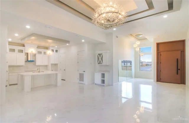 a large kitchen with a lot of counter space and stainless steel appliances
