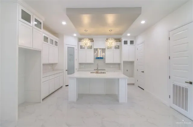 a view of kitchen with sink and refrigerator