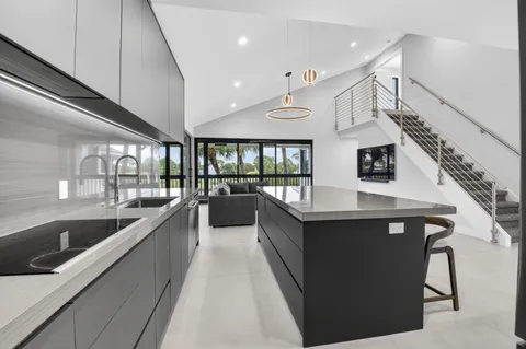 a large kitchen with stainless steel appliances granite countertop a lot of cabinets