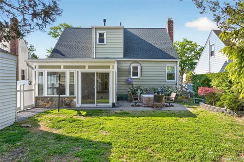 a view of a house with backyard porch and sitting area