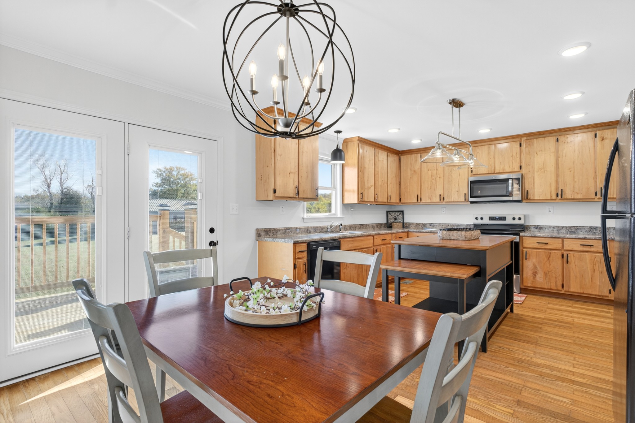 780 Champ Road Flintville, TN 37335 - Photo 12 of 45 a kitchen with stainless steel appliances granite countertop a stove a table and chairs