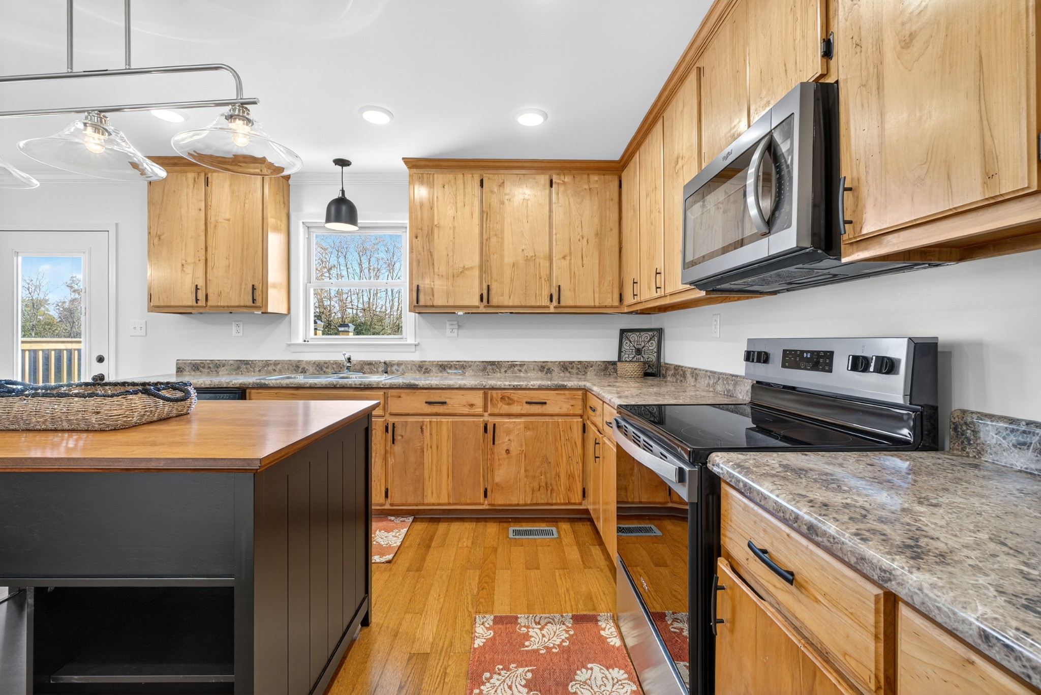 780 Champ Road Flintville, TN 37335 - Photo 17 of 45 a kitchen with stainless steel appliances granite countertop a sink stove and cabinets