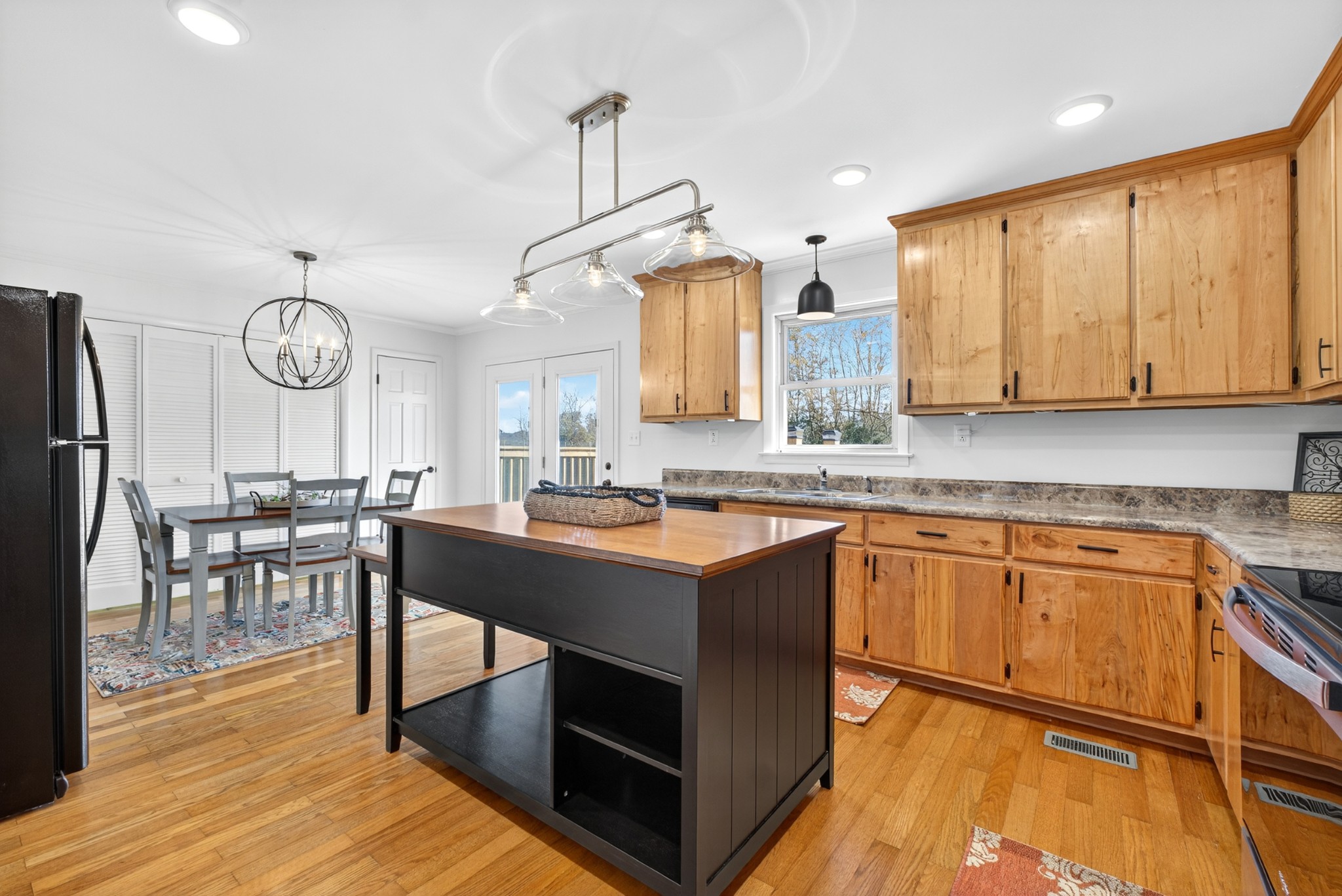 780 Champ Road Flintville, TN 37335 - Photo 19 of 45 a kitchen with stainless steel appliances granite countertop a stove a sink dishwasher and a refrigerator with wooden floor