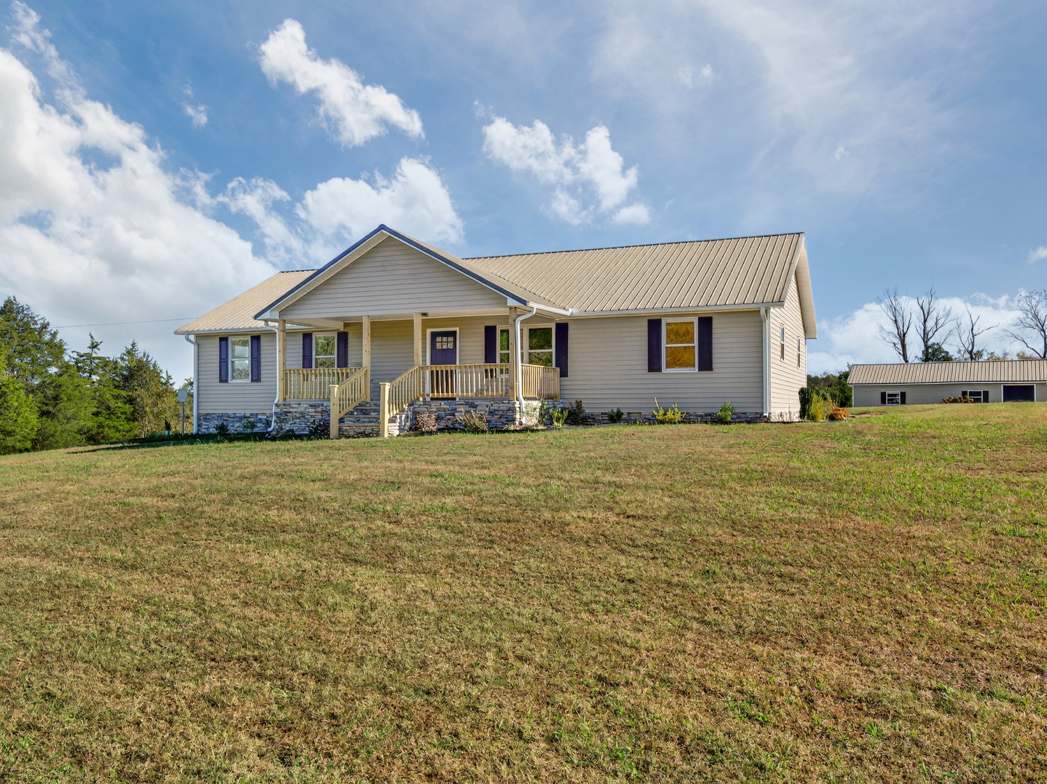 780 Champ Road Flintville, TN 37335 - Photo 2 of 45 a front view of a house with a garden