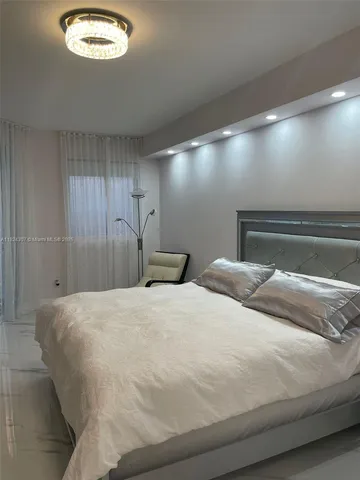 a bedroom with a bed and a night stand