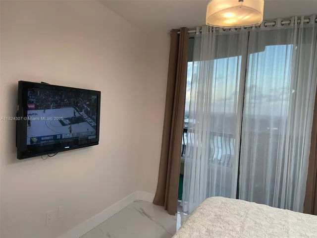 a bedroom with bed and mirror