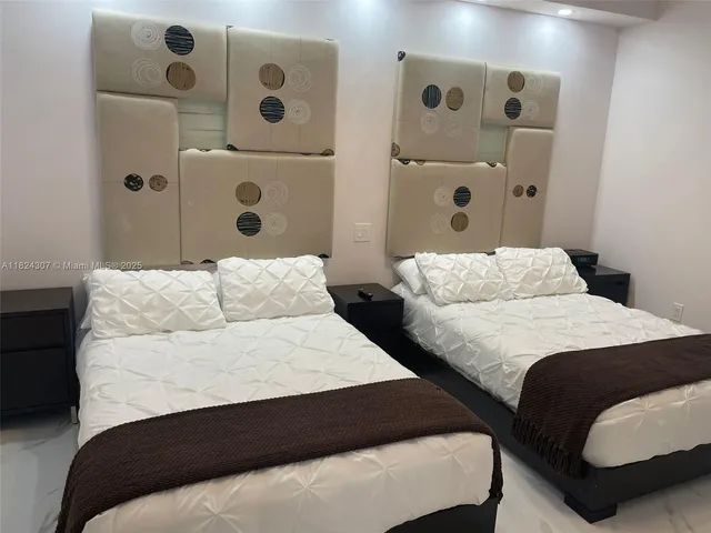 a bedroom with two beds and painted walls