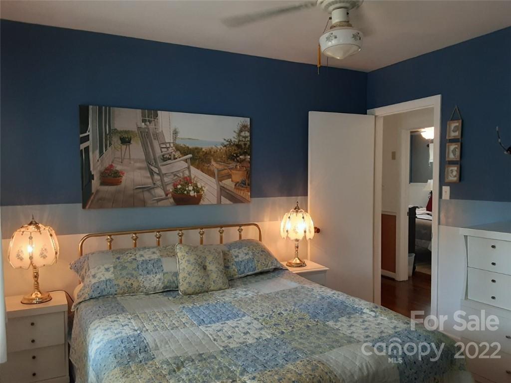 320 Scaleybark Road Charlotte, NC 28209 - Photo 21 of 27 a bed room with a bed and a painting on the wall