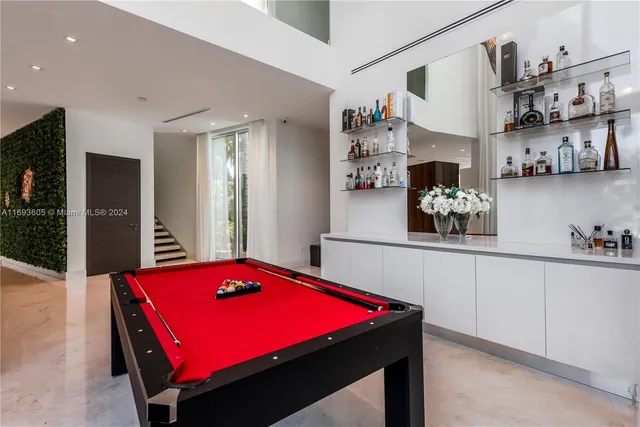 a white toilet sitting next to a bathroom sink and vanity