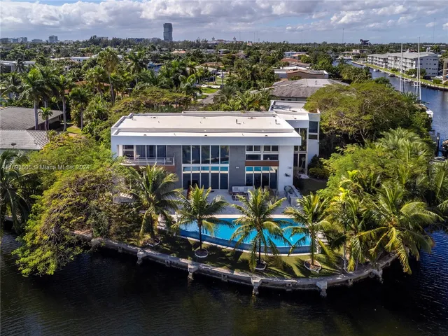 an aerial view of residential houses with outdoor space and swimming pool