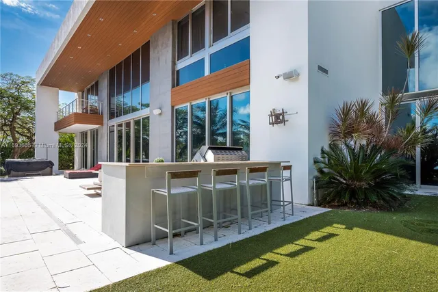 a patio with yard and outdoor seating