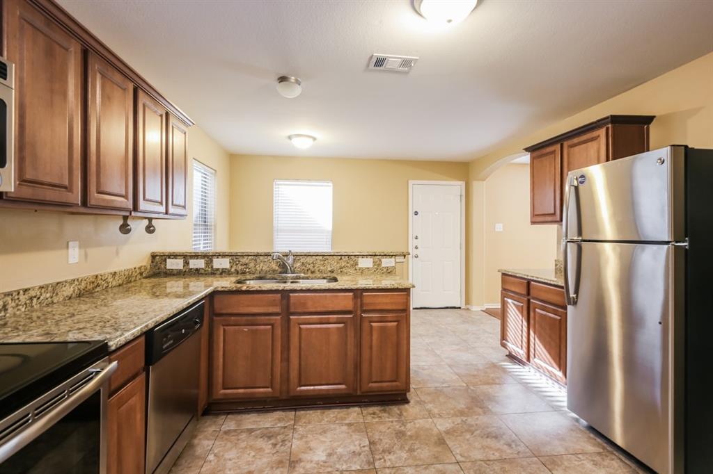148 Cliff Height Circle Dallas, TX 75241 - Photo 11 of 17 a kitchen with a sink stove and refrigerator