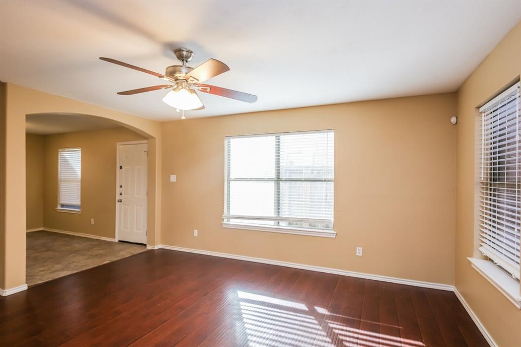 148 Cliff Height Circle Dallas, TX 75241 - Photo 8 of 17 a view of an empty room with window and wooden floor