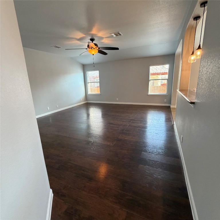 1115 Sunny Meadows Loop Georgetown, TX 78626 - Photo 12 of 36 Unfurnished room with dark wood-type flooring, plenty of natural light, and a ceiling fan
