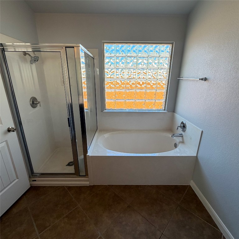 1115 Sunny Meadows Loop Georgetown, TX 78626 - Photo 19 of 36 Bathroom featuring a garden tub, a stall shower, a textured wall, and dark tile patterned flooring