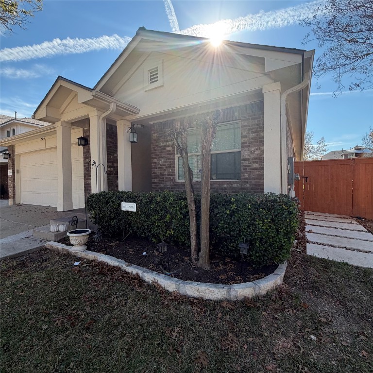 1115 Sunny Meadows Loop Georgetown, TX 78626 - Photo 34 of 36 View of front facade with brick siding, a garage, and driveway