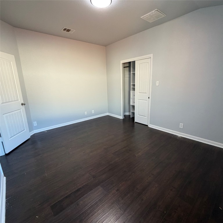 1115 Sunny Meadows Loop Georgetown, TX 78626 - Photo 10 of 36 Empty room with dark wood-style floors and baseboards