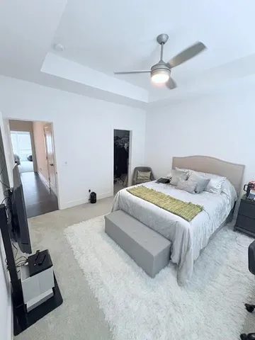 a bedroom with a bed and a chair