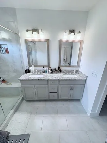 a bathroom with a sink mirror and vanity
