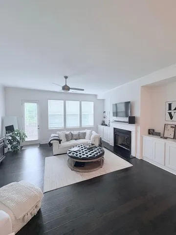 a living room with furniture fireplace and window