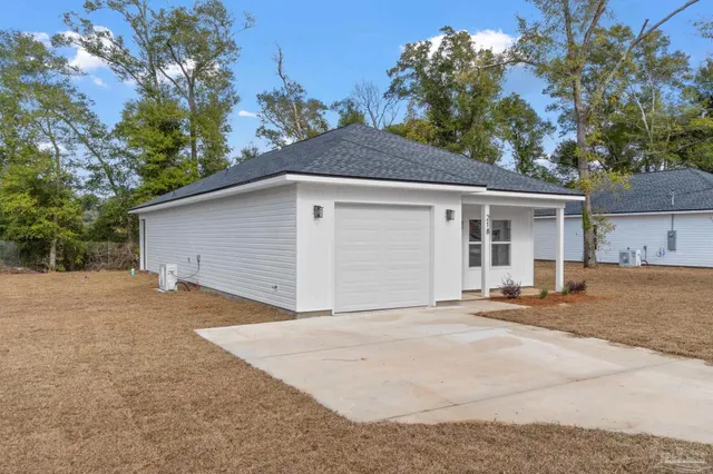 a view of a house with a yard and garage