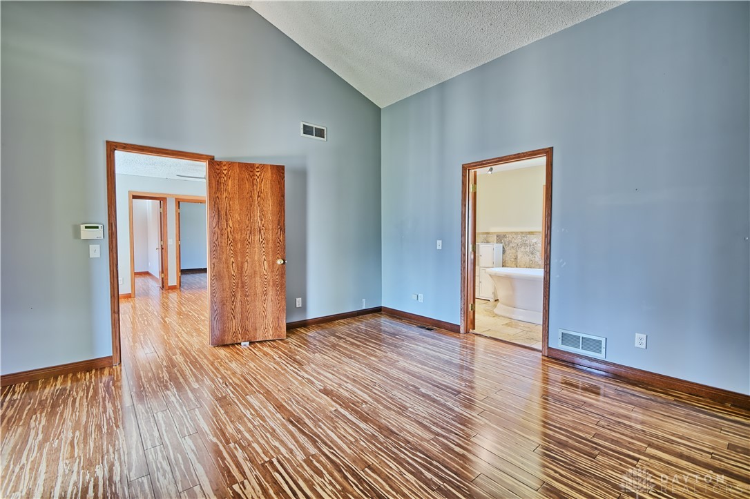 8711 Nicole Lane Springboro, OH 45066 - Photo 37 of 87 This primary bedroom features high ceilings and polished wood flooring.