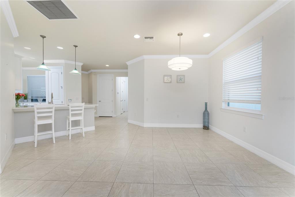 13869 Alafaya Street Venice, FL 34293 - Photo 22 of 75 a view of a kitchen with table and chairs