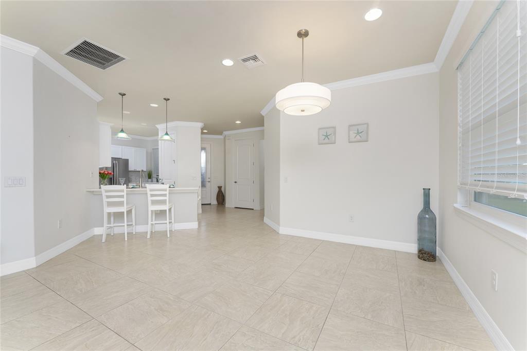 13869 Alafaya Street Venice, FL 34293 - Photo 23 of 75 a view of a kitchen with a table and chairs