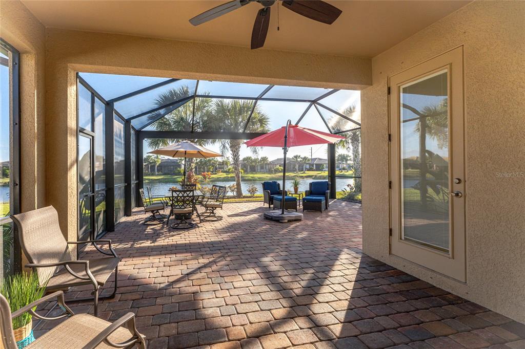 13869 Alafaya Street Venice, FL 34293 - Photo 36 of 75 a view of a patio with a table and chairs under an umbrella