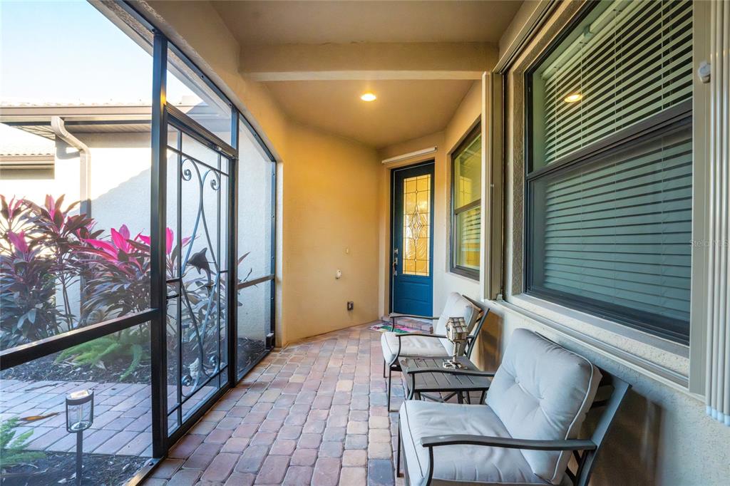 13869 Alafaya Street Venice, FL 34293 - Photo 4 of 75 a balcony with furniture and wooden floor