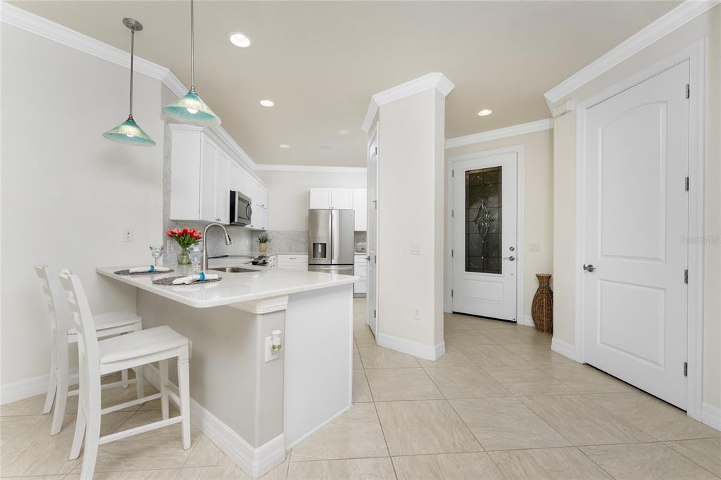 13869 Alafaya Street Venice, FL 34293 - Photo 5 of 75 a kitchen with kitchen island a sink appliances and cabinets