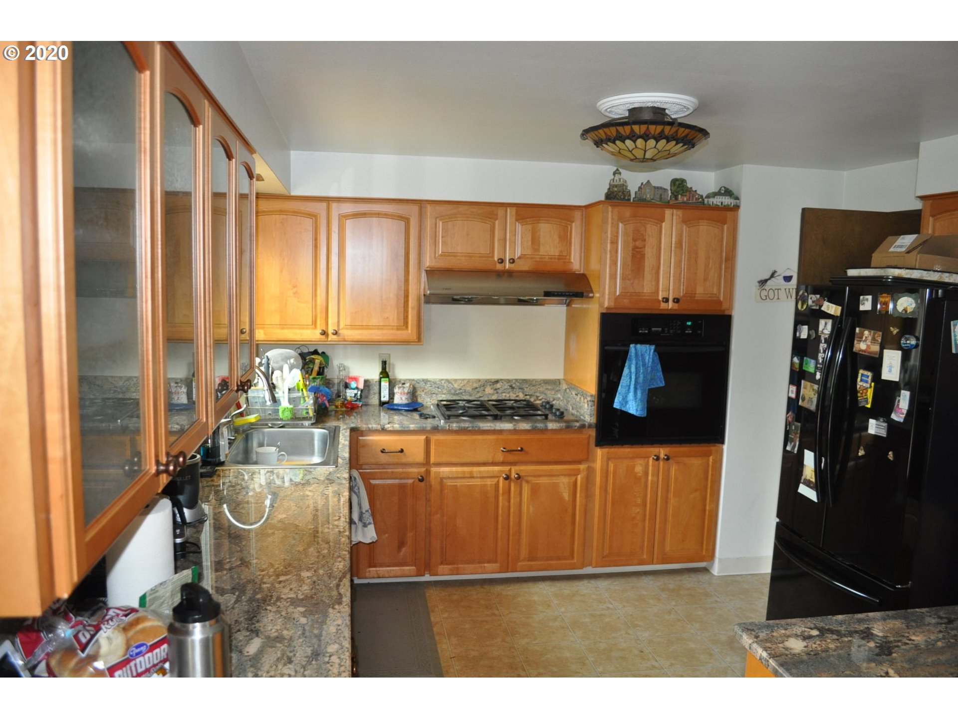 9179 Southwest Lee Road Gaston, OR 97119 - Photo 8 of 30 a kitchen with stainless steel appliances granite countertop a sink a stove and refrigerator