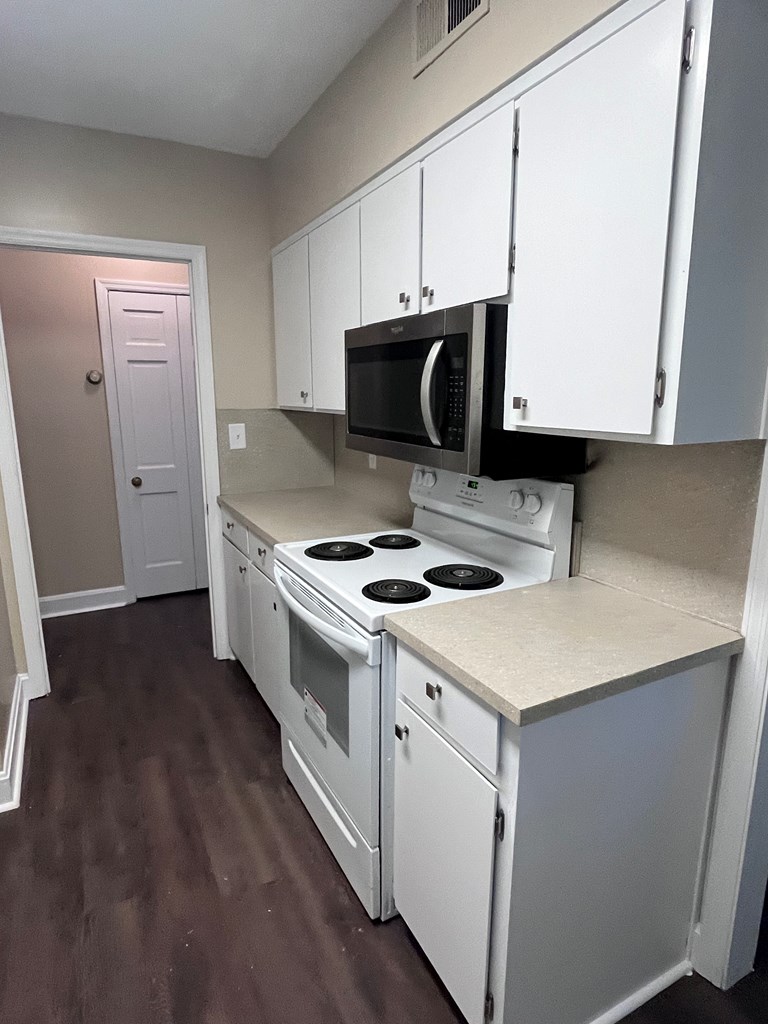 2312 15th Street, Unit C Columbus, GA 31906 - Photo 12 of 26 a kitchen with a stove and a microwave