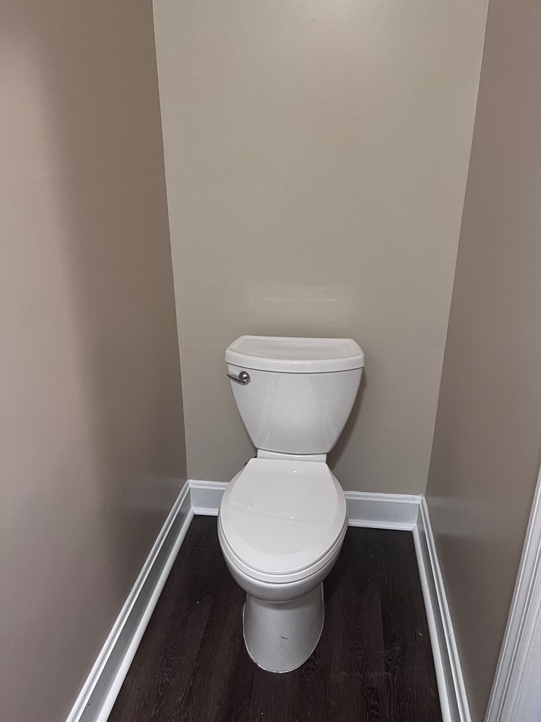 2312 15th Street, Unit C Columbus, GA 31906 - Photo 17 of 26 a white toilet sitting next to a small white wall