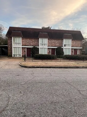 a front view of house with yard and garage