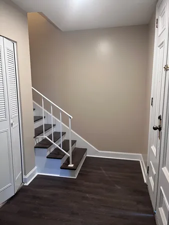 a view of entryway with stairs and wooden floor