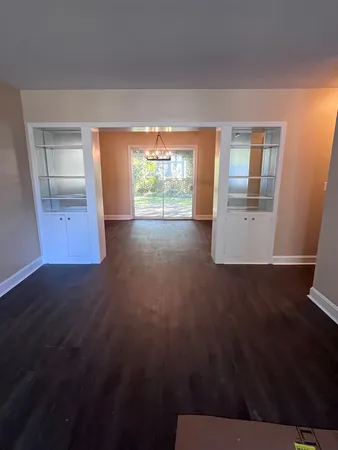 a view of utility room with wooden floor and window