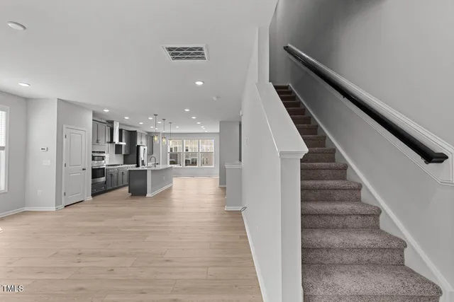 a view of kitchen with wooden floor and electronic appliances