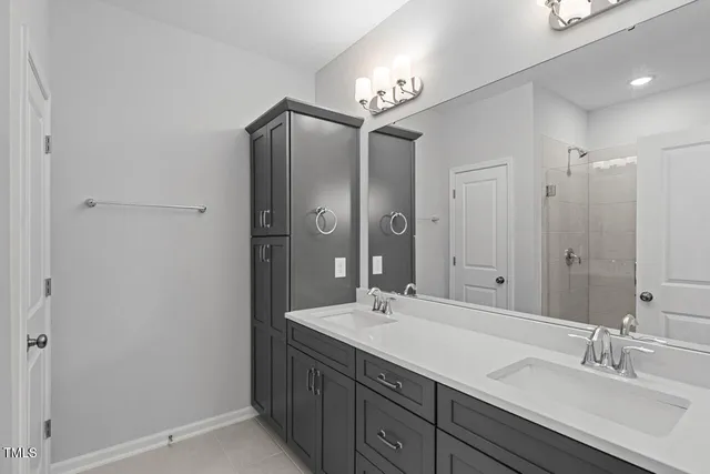 a bathroom with a double vanity sink and a mirror