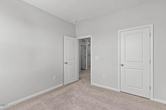 an empty room with closet area